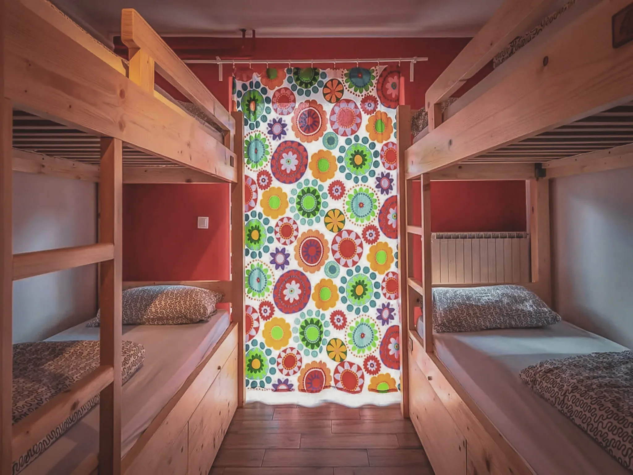 Comfortable room with bunk beds and colourful curtains, ideal for an adventure in Slovenia.