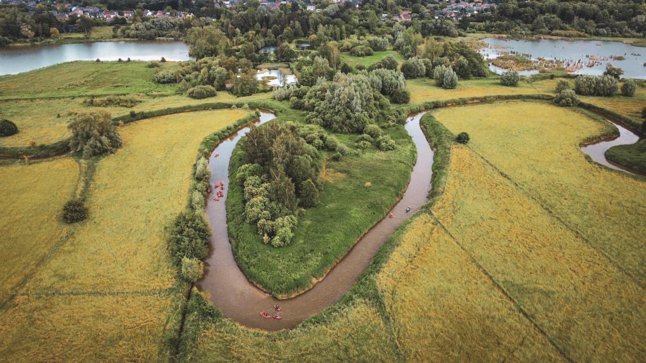 Forest landscape with packraft adventurers.