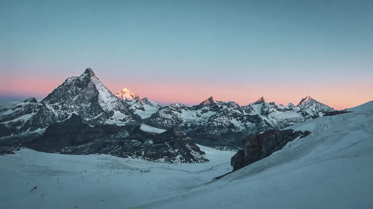 Sunset over the snow-capped mountains: an invitation to an alpine adventure in Zermatt.