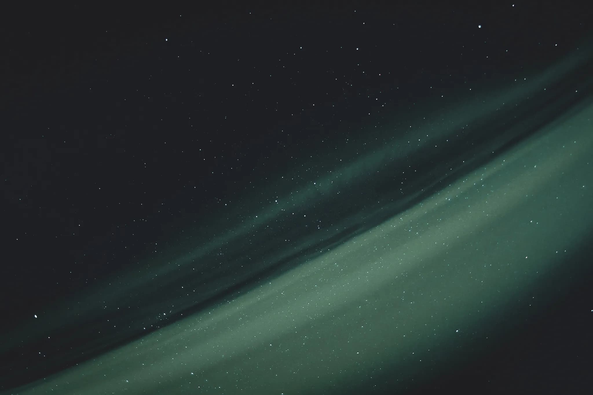 Luminous starry sky with bands of green light, reminiscent of the northern lights in Lapland.