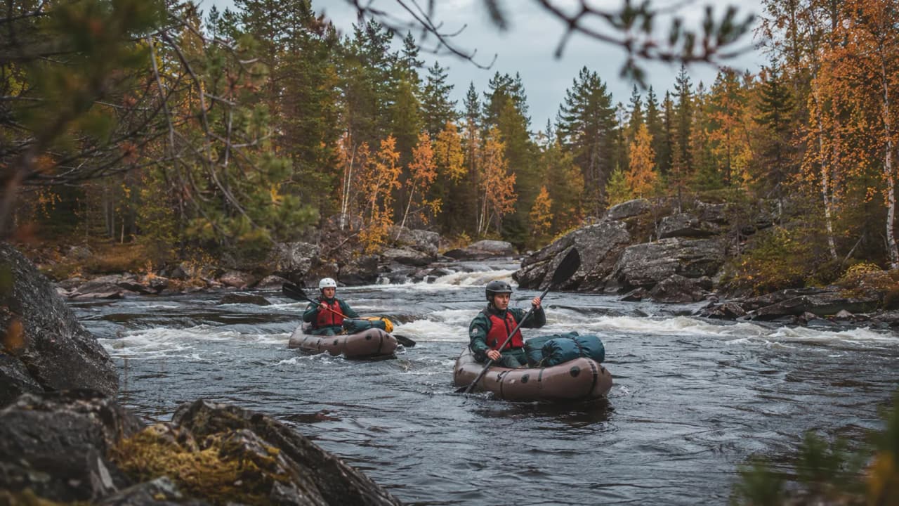 Vue panoramique sur la rivière encaissée, entourée de forêts verdoyantes sous un ciel ensoleillé.