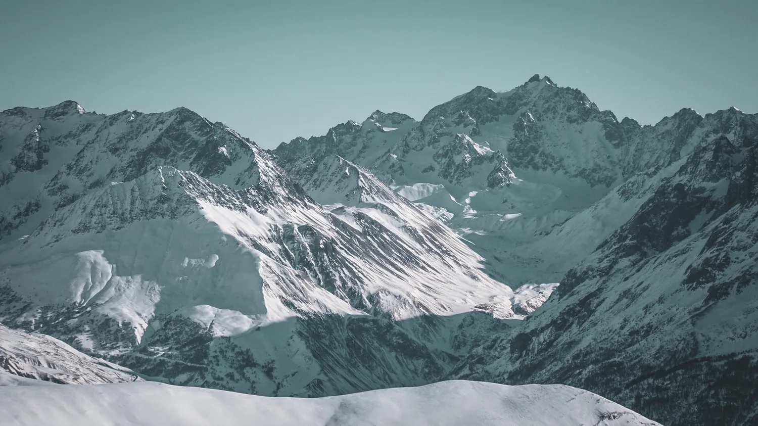 Snow-covered mountain scenery, majestic peaks, an invitation to ski touring adventure.
