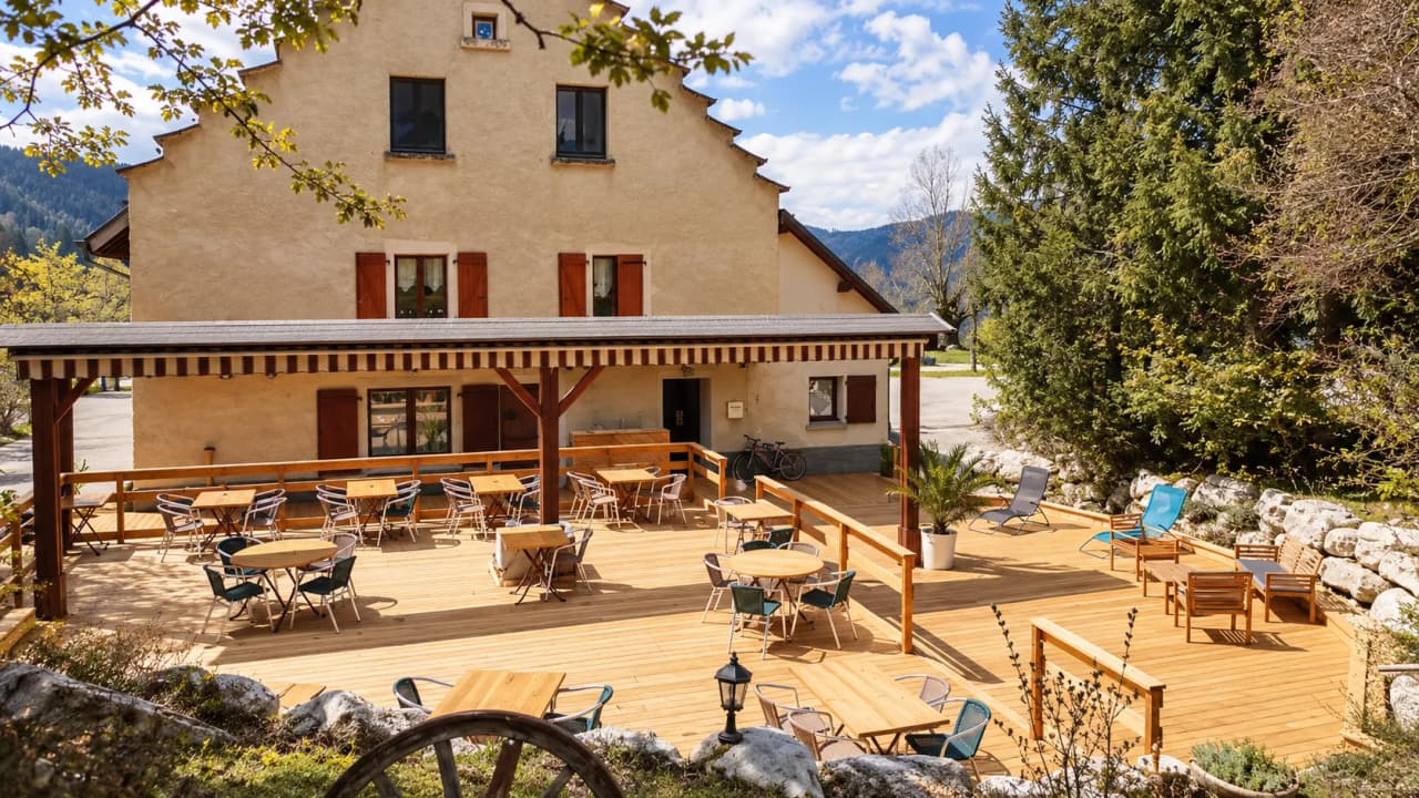 A charming inn with a wooden terrace, ideal for relaxing after a hike in the Vercors.