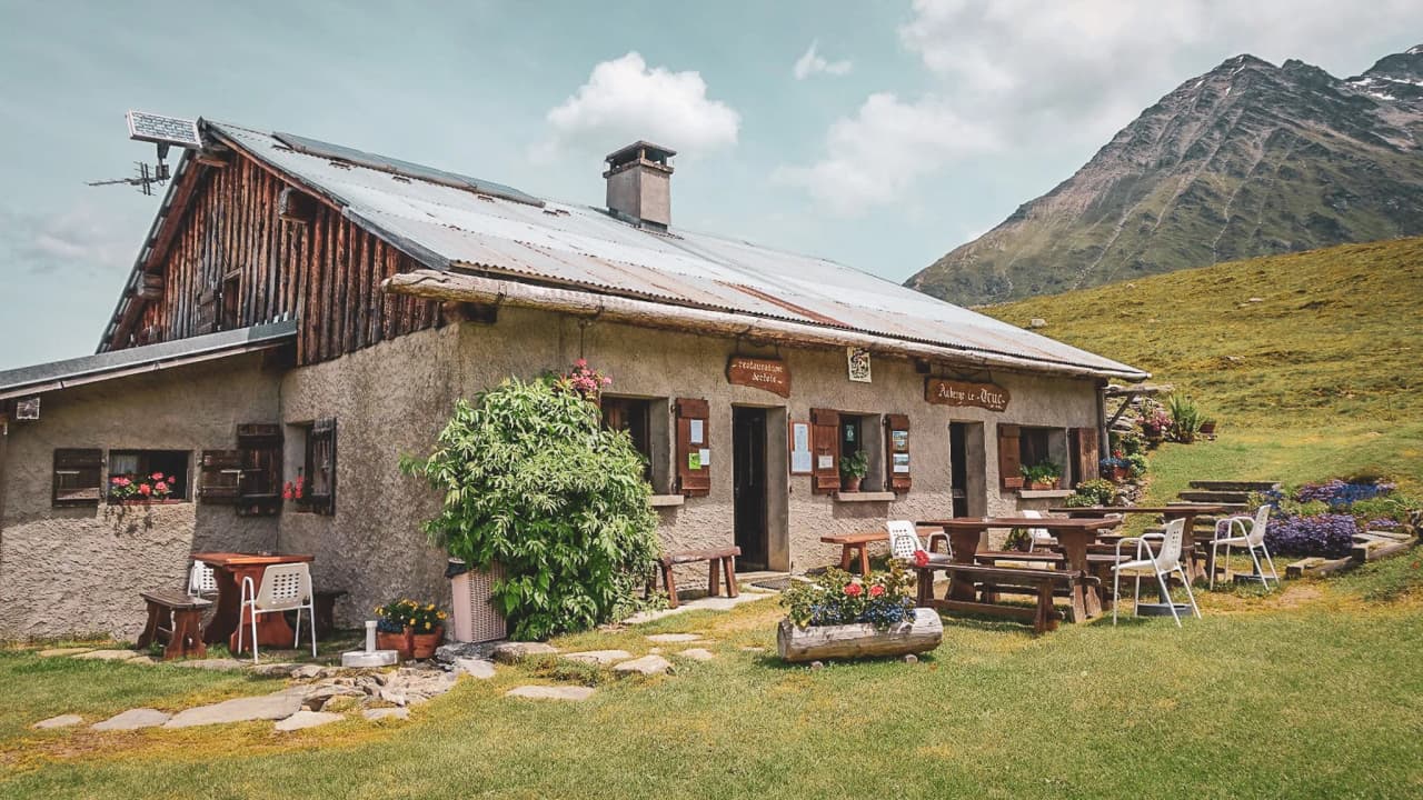 A picturesque Mountain hut in the heart of the Alps, surrounded by lush green landscapes and majestic mountains.