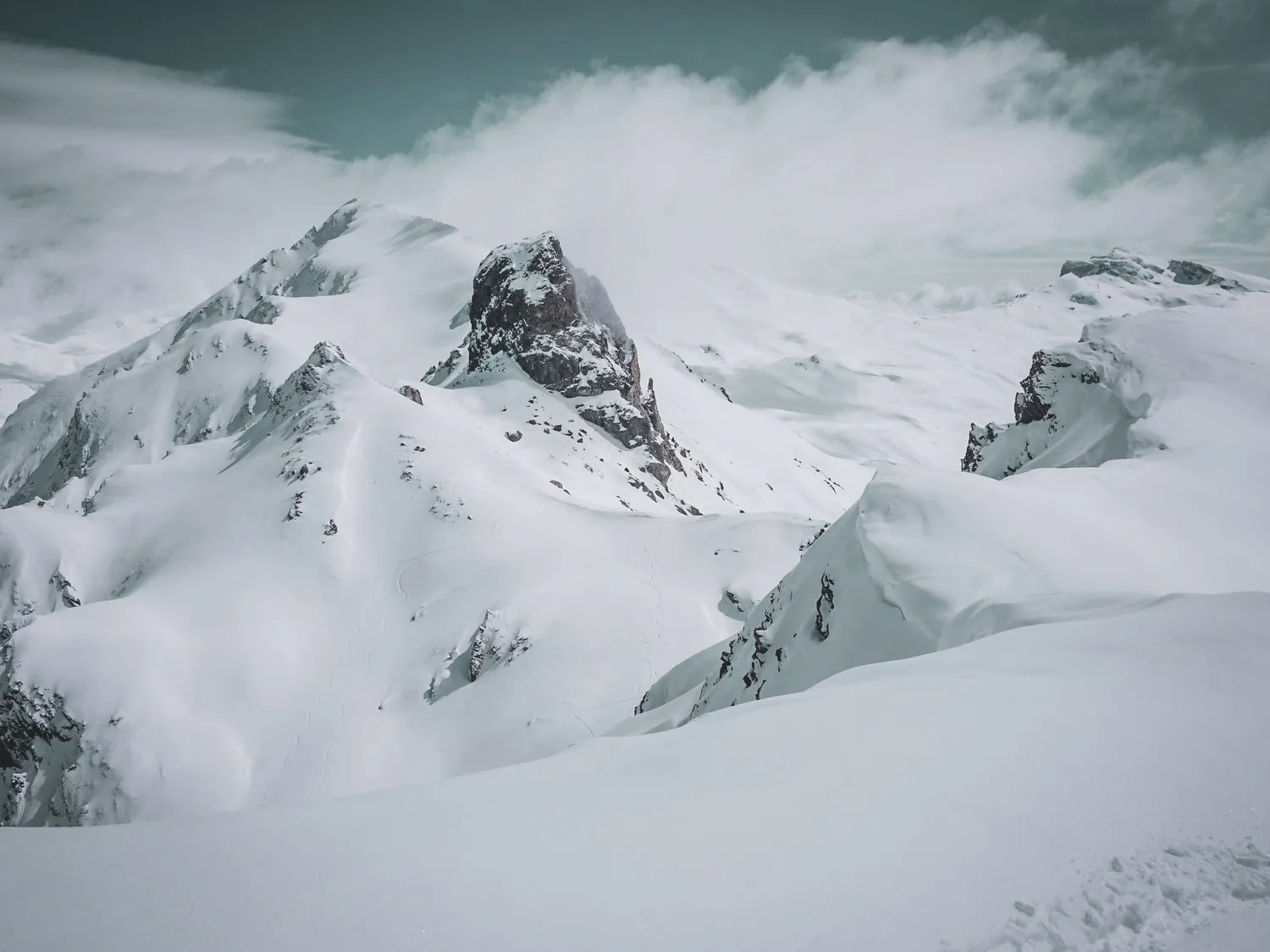 Snow-covered mountain scenery with majestic ridges, inviting you to embark on a ski touring adventure.