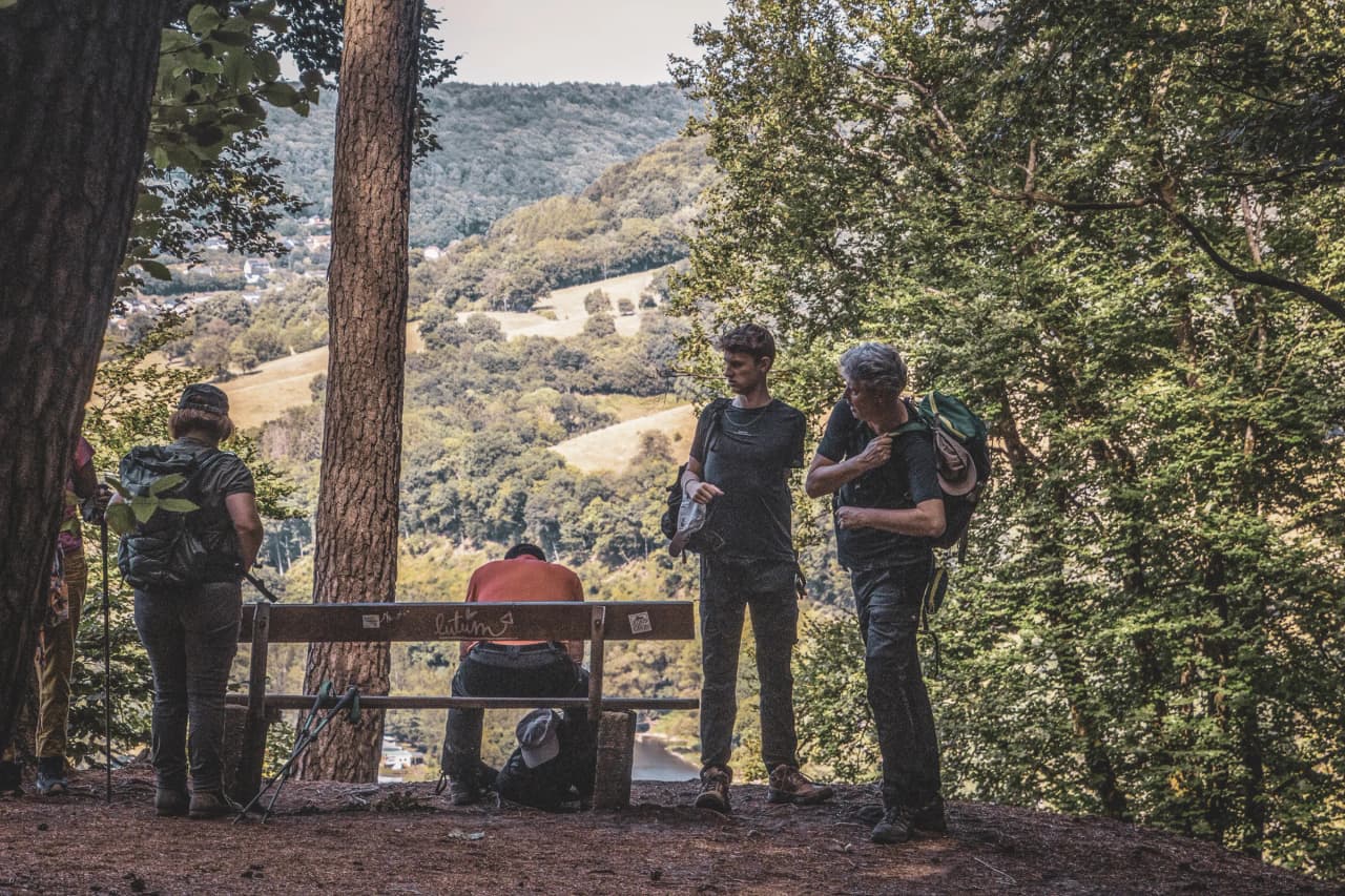 Hikers admiring the panoramic view in Luxembourg's Little Switzerland, an enchanting place.