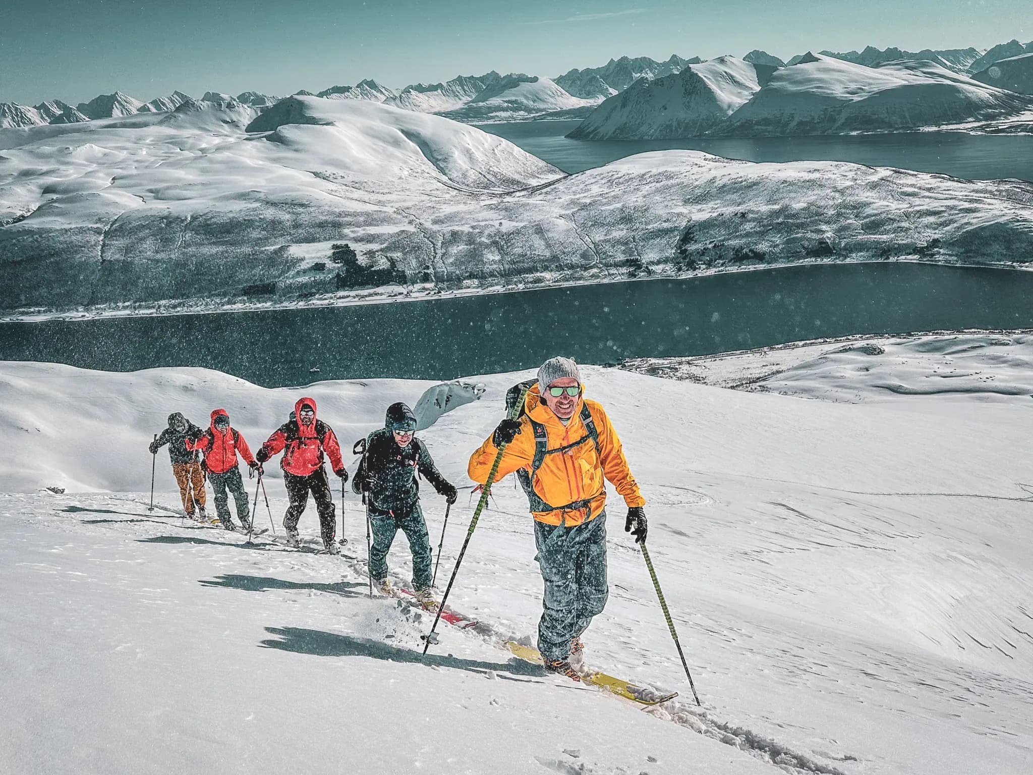 Group of adventurers ski touring in the majestic Lyngen Alps, Norway.