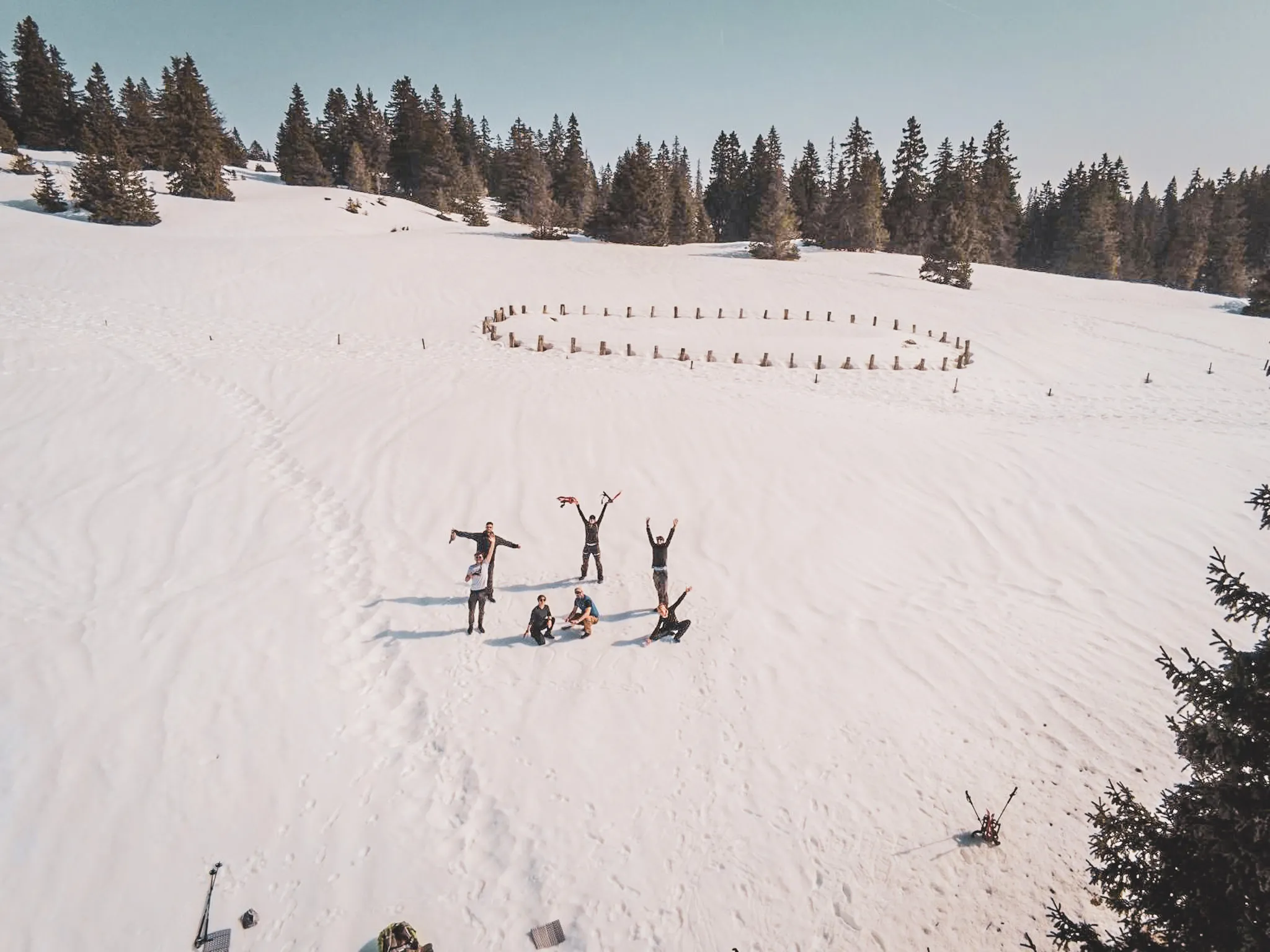 A group of adventurers on snowshoes in a snowy landscape surrounded by majestic fir trees.