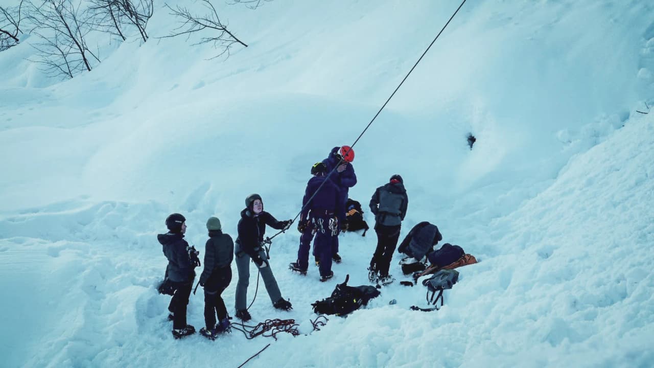 A group on an icefall expedition, surrounded by sparkling snow in the Alps.
