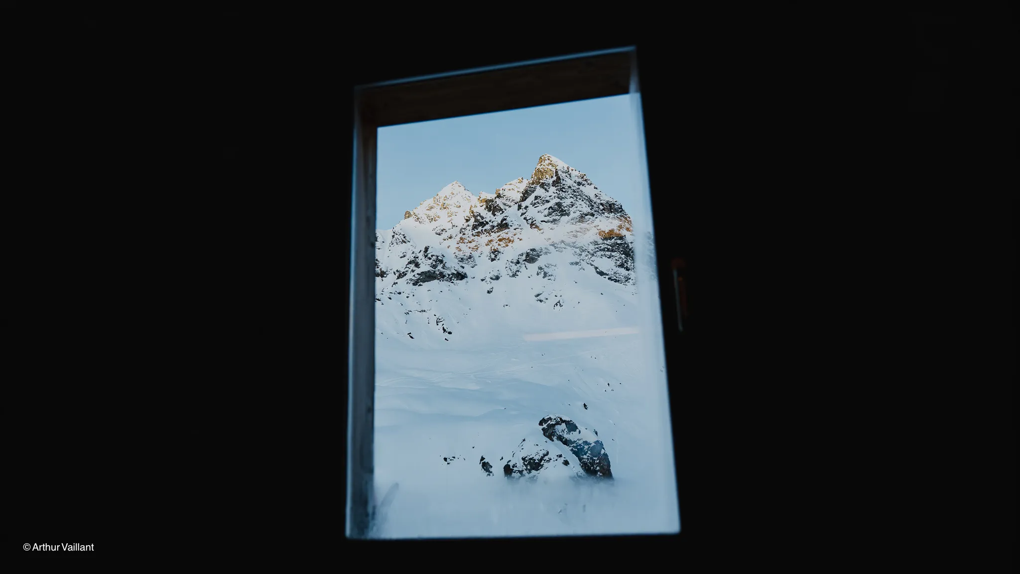 A view from a window of snow-capped peaks, promising unforgettable alpine adventures.