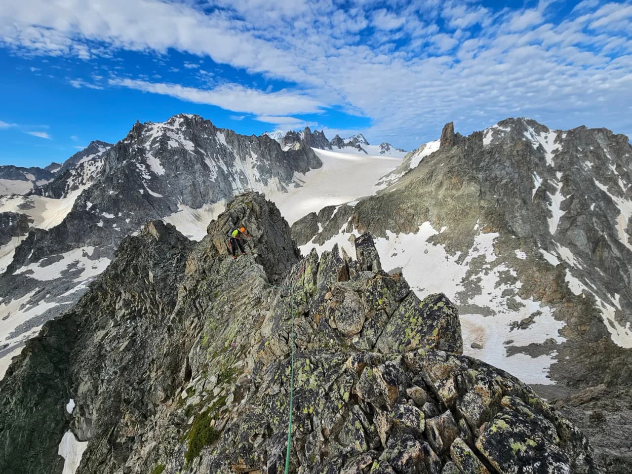 A sublime rocky ridge in Chamonix, with Mont Blanc in the background and a brilliant blue sky.