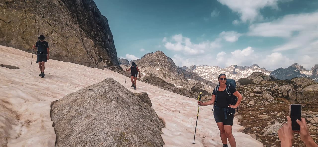 Hiking in the Pyrenees, on a glacier, with spectacular mountains in the background.