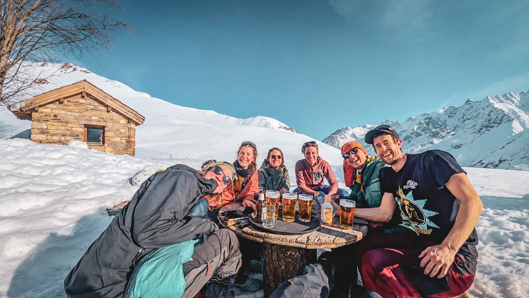 Vast snow-capped peaks under blue skies, an invitation to adventure on ski touring.