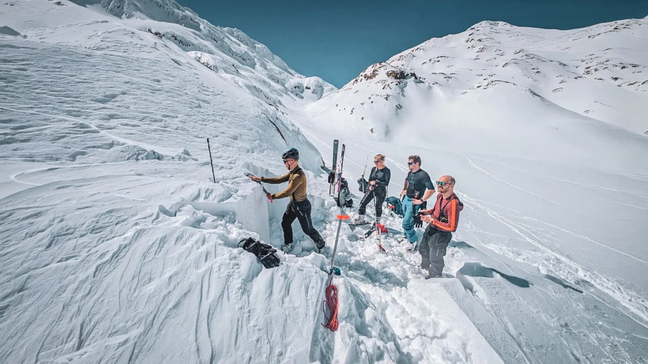 A group of friends ski-touring over the Great St Bernard Pass, deciphering the brilliant snow.