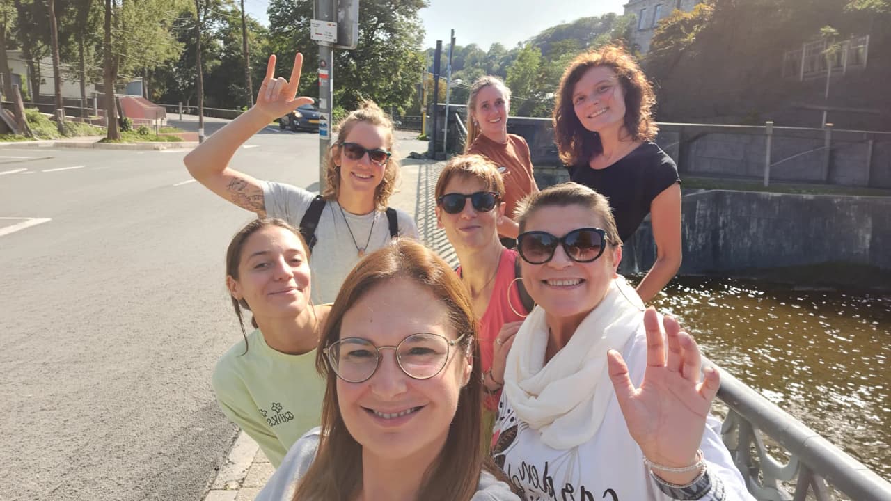 A joyful outdoor group, ready for a yoga retreat in an enchanting setting.