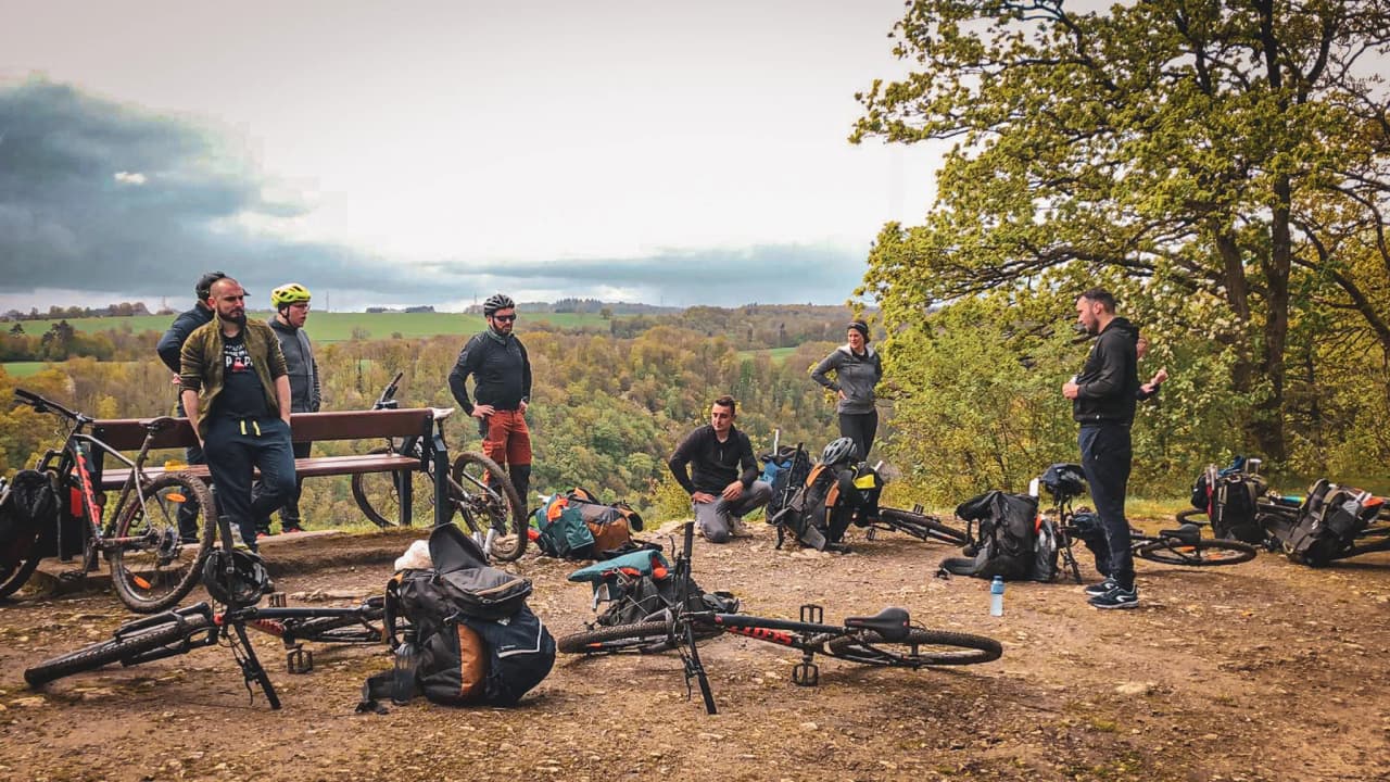 A group of adventurers on mountain bikes, surrounded by nature, ready for an exhilarating day in the great outdoors.