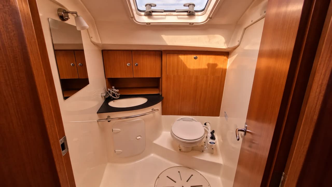 Salle de bain moderne et lumineuse à bord d'un voilier, prête pour une aventure en mer.