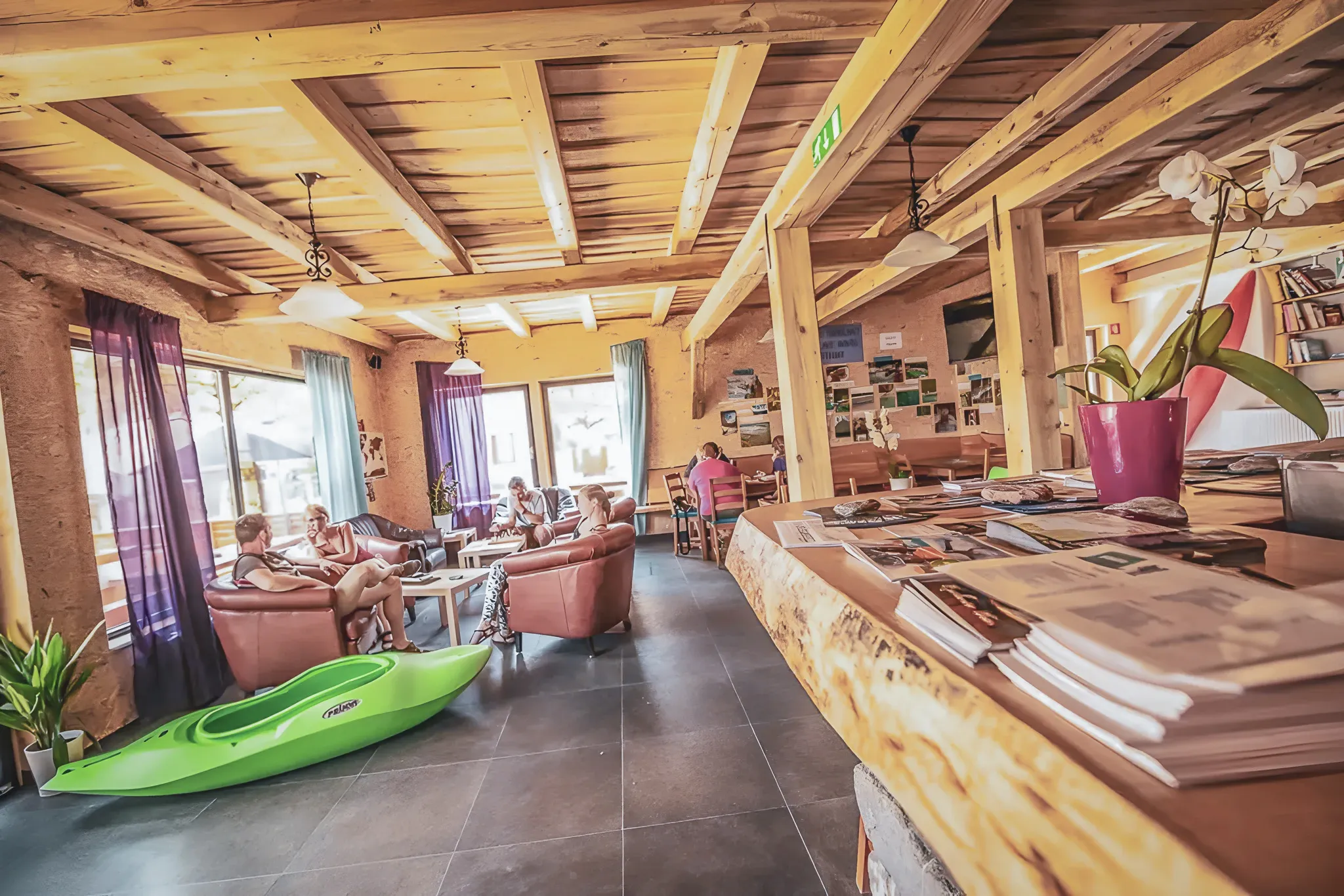 A cosy space with sofas, a green kayak and views of Slovenian rivers.