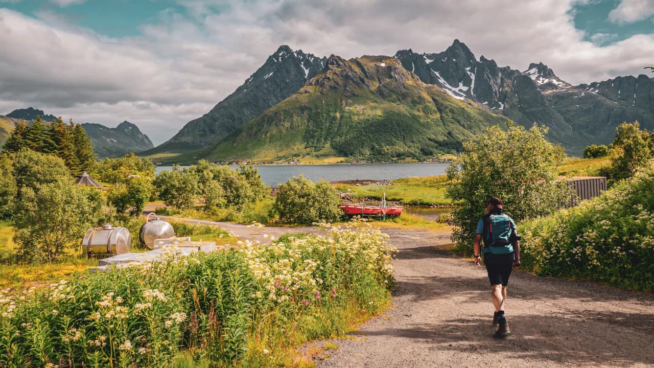 A sunny hike on the Lofoten Islands, with views of majestic mountains and a lake.