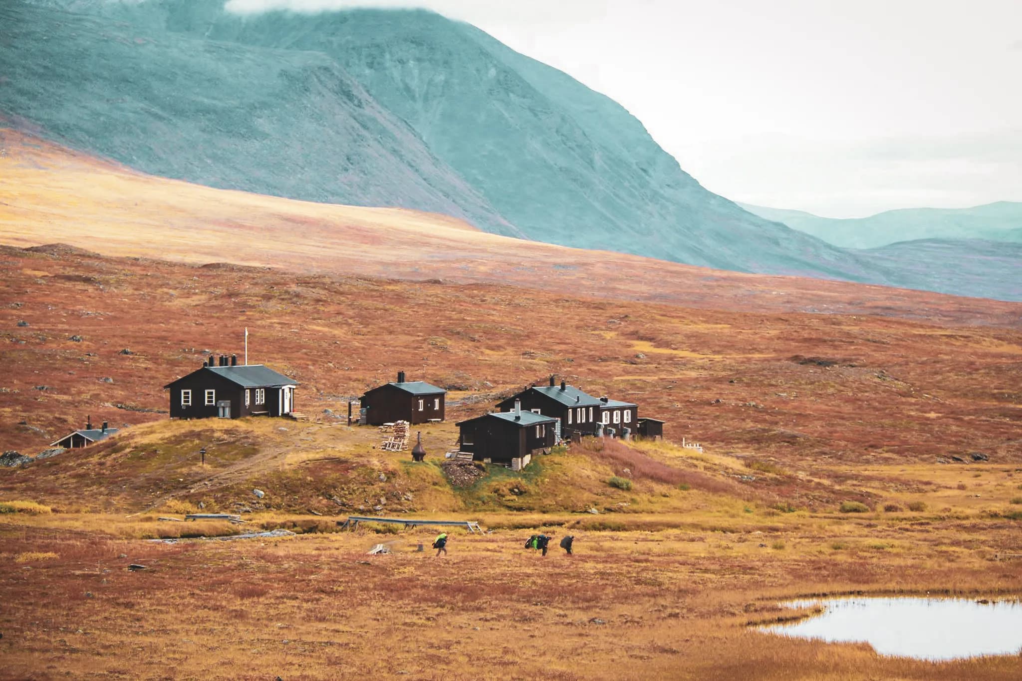 A serene landscape of Swedish Lapland, with picturesque cabins surrounded by golden valleys.