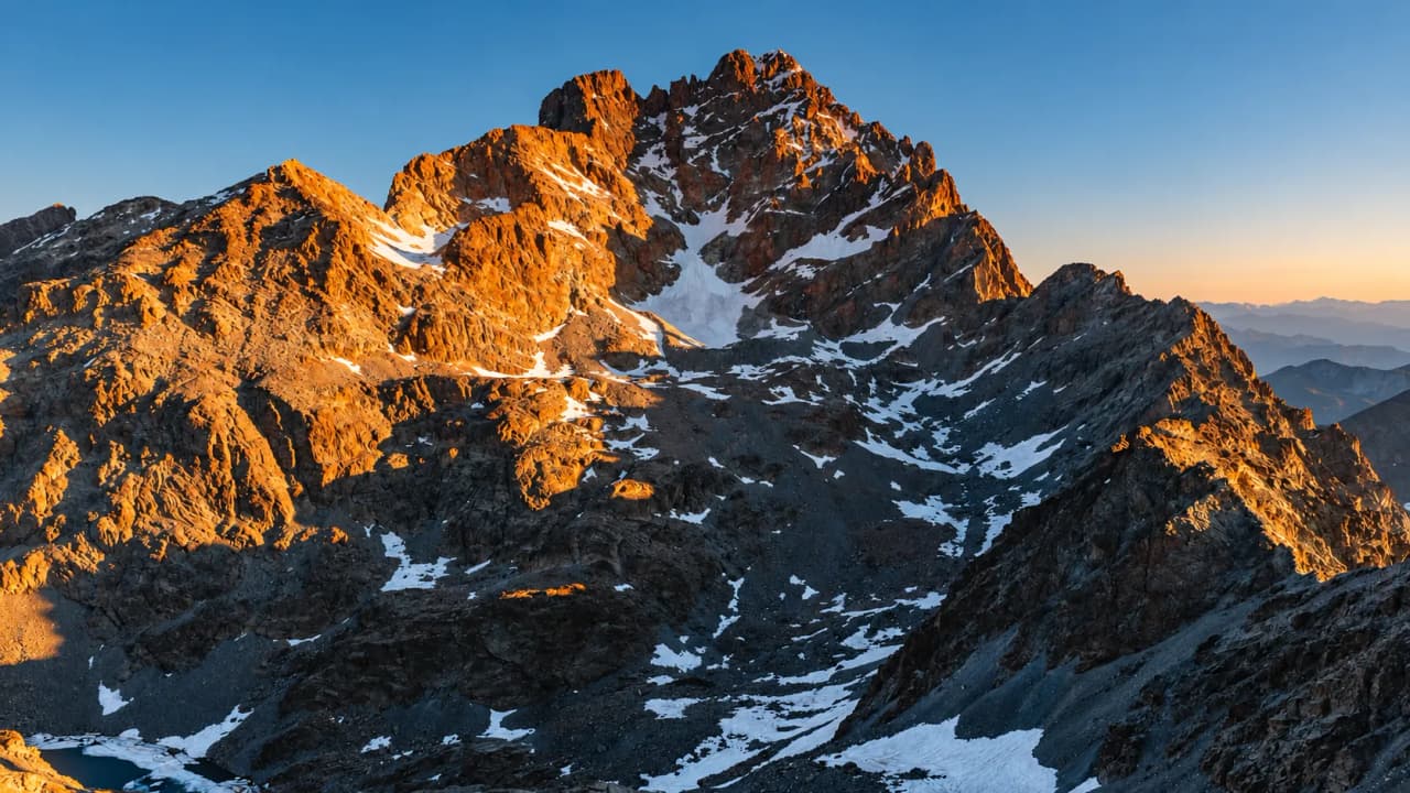 A majestic view of Mount Viso at sunrise, illuminating the peaks and the eternal snows.