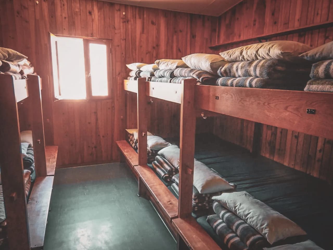 Wooden accommodation with bunk beds, ideal for alpine adventures.