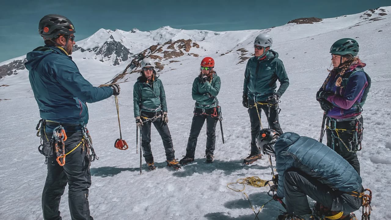 A team of trainee mountaineers on the snow, with the majestic Breithorn in the background.