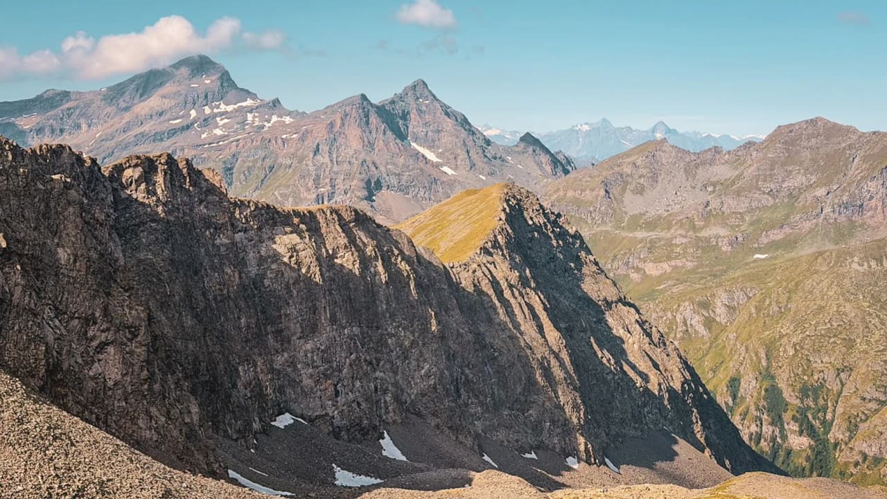 A majestic panorama of the Monte Rosa mountains beneath a blue sky, beckoning you to set off on an adventure.