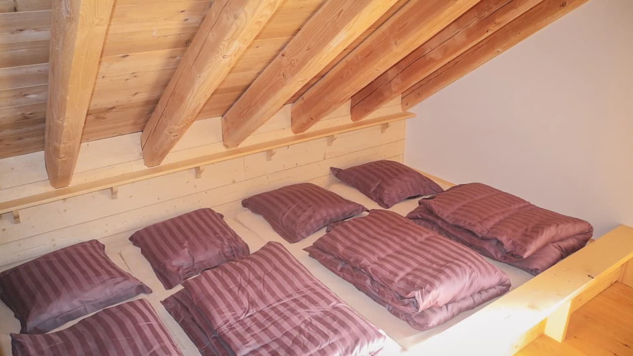 Chambre accueillante avec lits superposés en bois, parfaite pour un séjour de ski à La Grave.