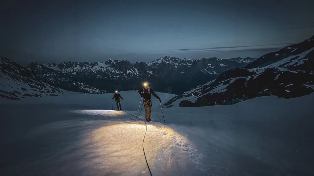 Climb beneath the stars: adventurers on the illuminated snow, heading for Mont Blanc.