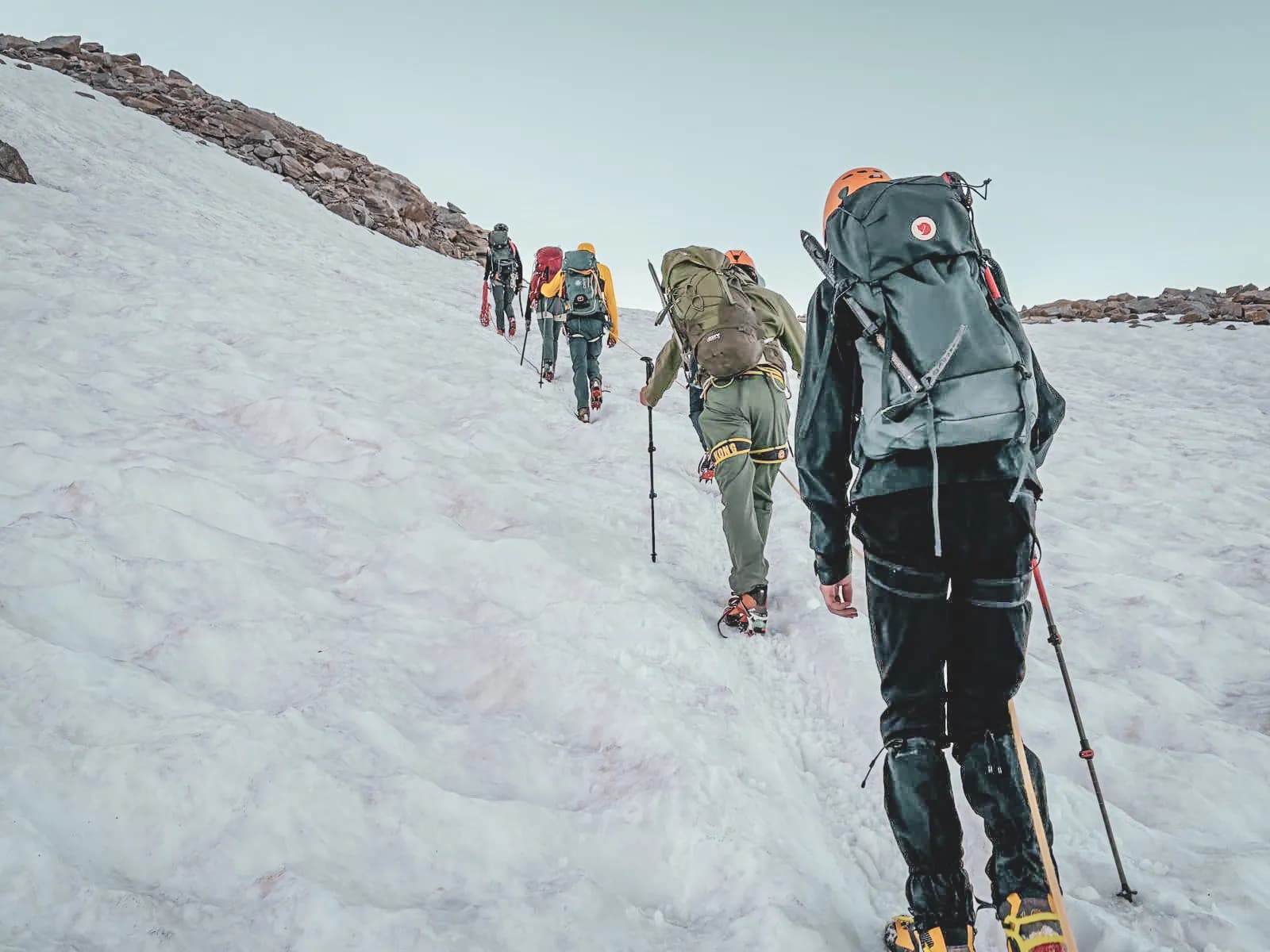 A group of mountaineers climb a snowy slope, ready to conquer the Gran Paradiso.