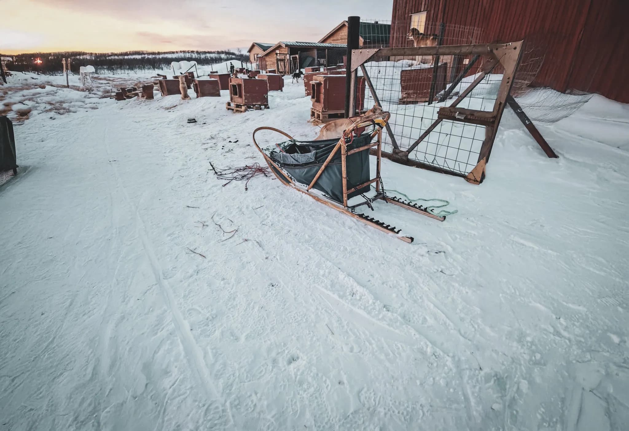 A wooden sleigh on the snow, surrounded by Mountain huts, in the heart of magical Lapland.