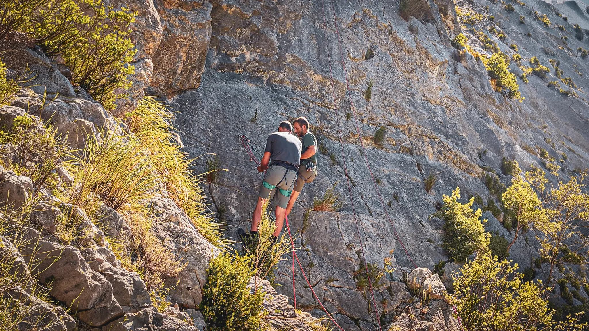 Two mountaineers are preparing to climb a majestic rock face on Mont Aiguille.