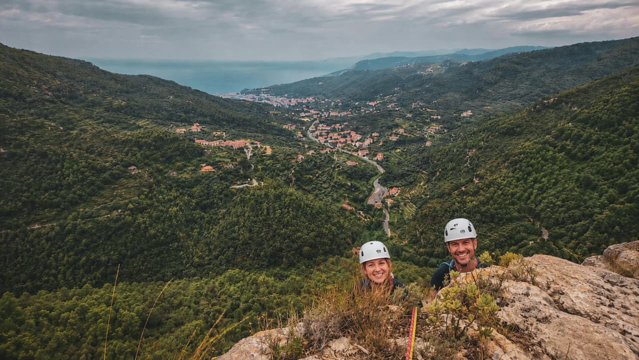 Scenic climbing in Finale Ligure, with views of the Mediterranean and the lush green valley.