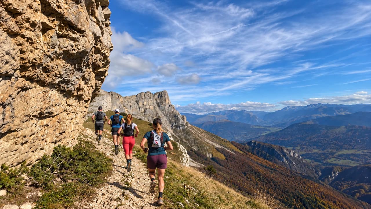 Runners make their way along a mountain trail, surrounded by breathtaking views in the Vercors.