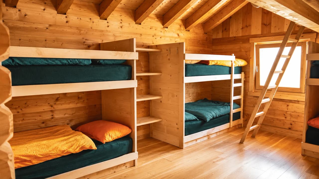 A cosy wooden chalet with bunk beds, ideal for relaxing after a day’s mountaineering.