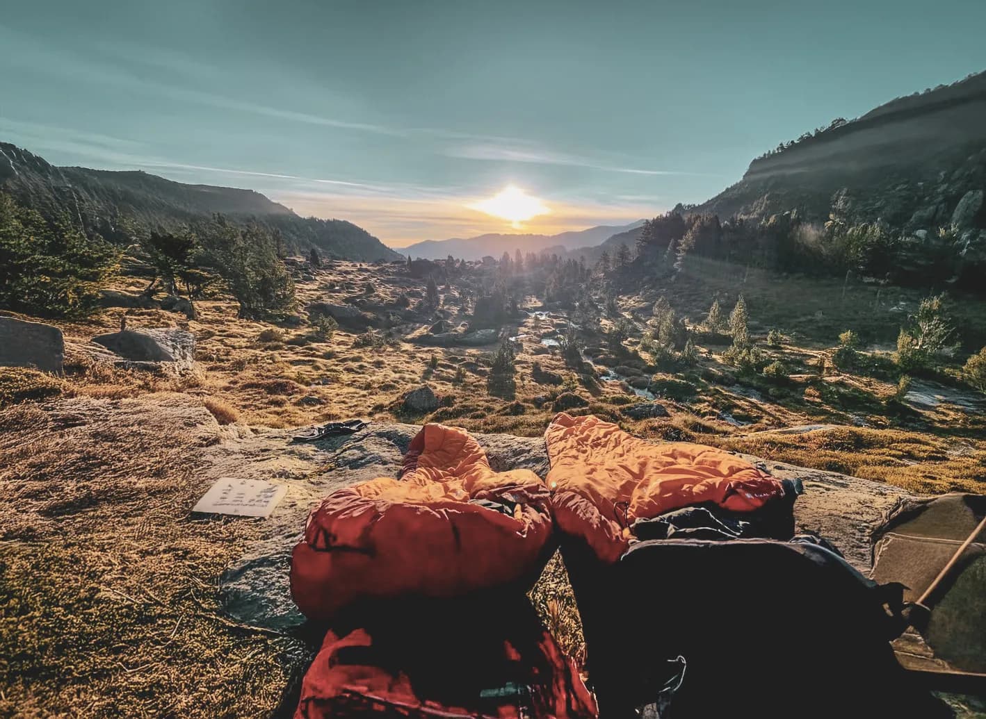 Sunrise over a wild Vercors landscape, with sleeping bags ready for adventure.