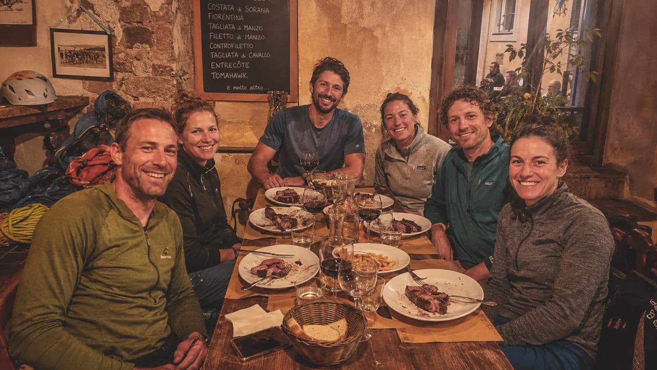 A cheerful group share a hearty meal after a day’s climbing in Finale Ligure.