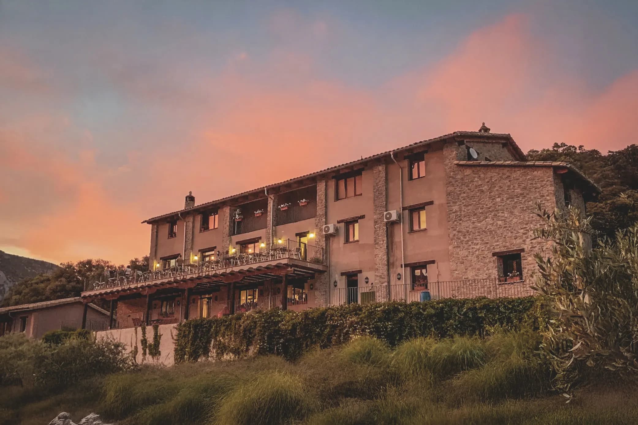 A cosy chalet at dusk, surrounded by greenery, perfect for adventures in the great outdoors.