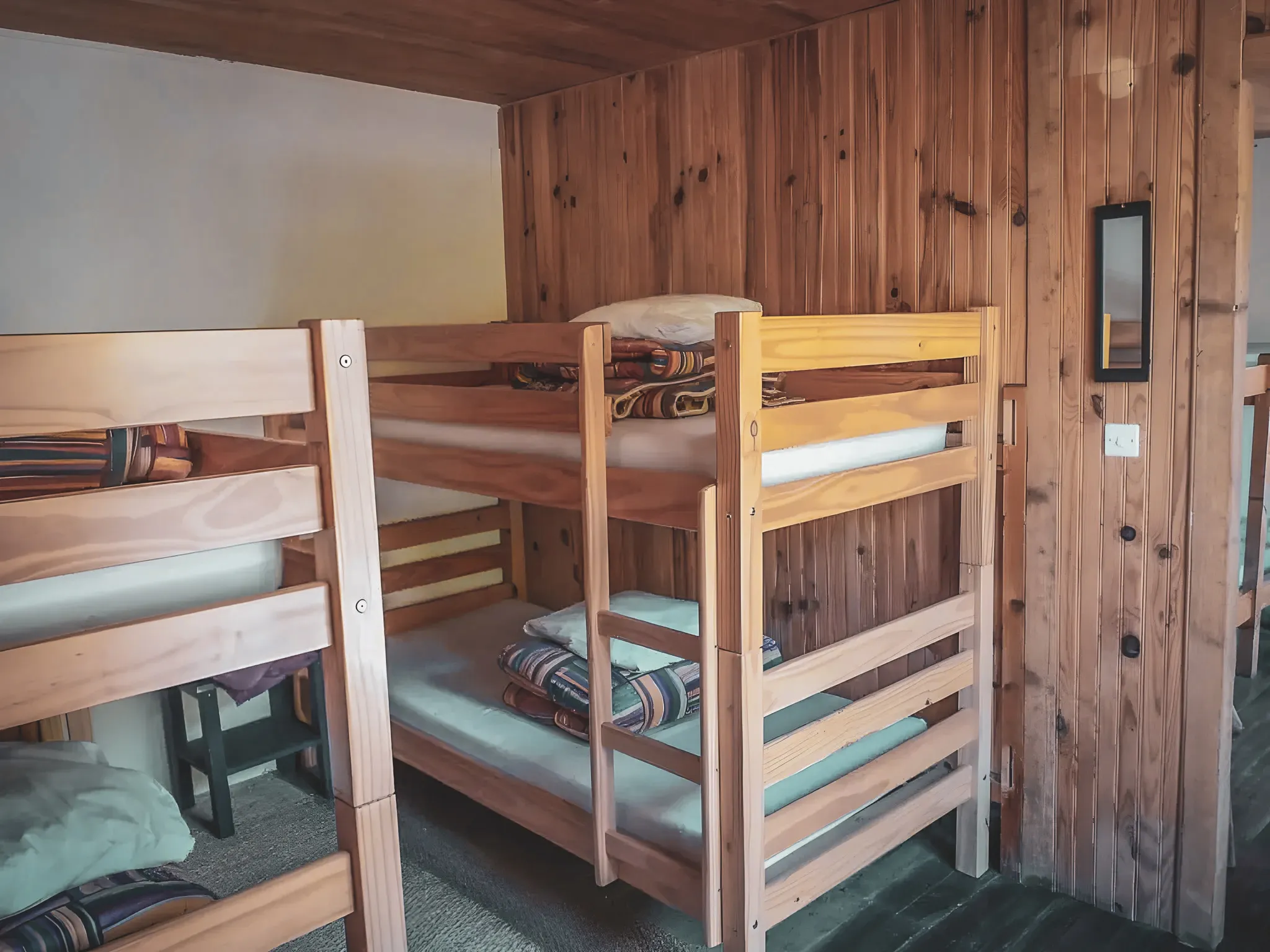 Warm wooden rooms with bunk beds, perfect for a mountain adventure.