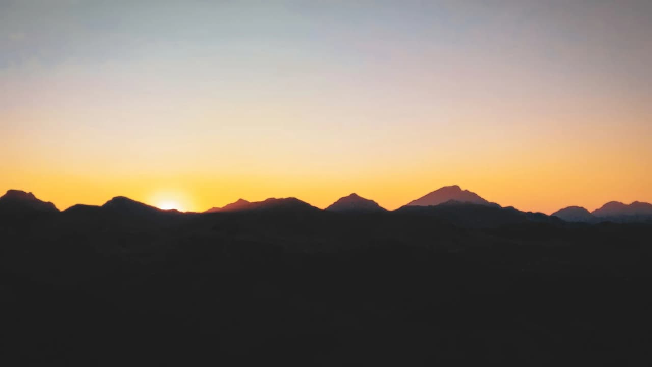 The silhouette of the mountains at sunset, promising unforgettable alpine adventures.