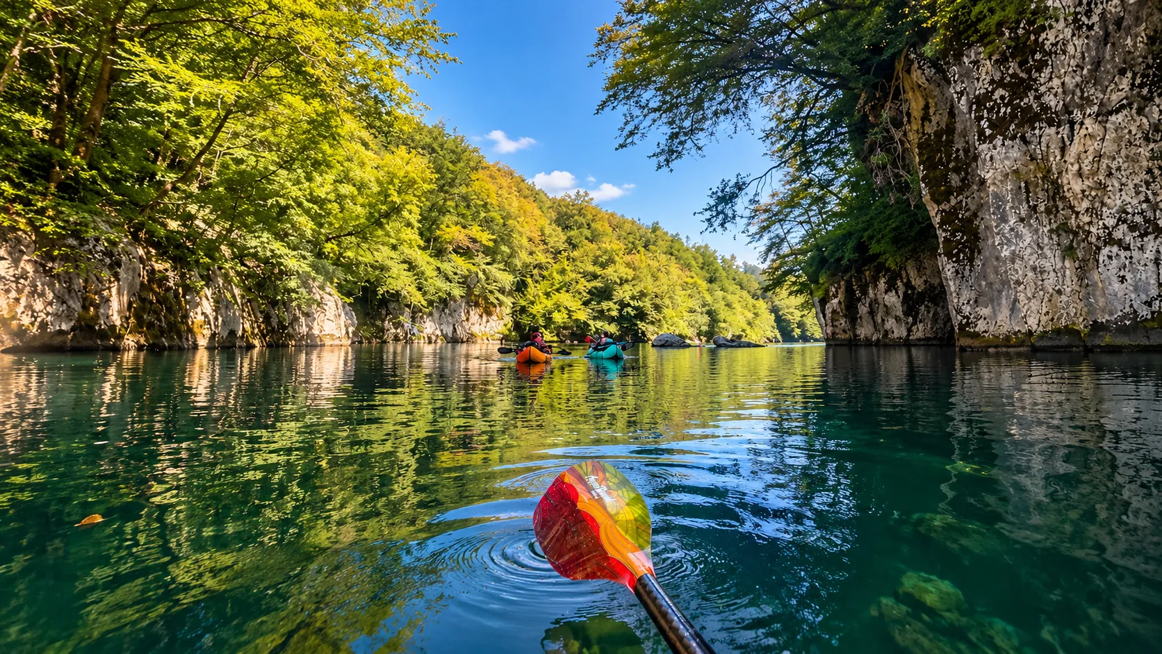 Deux kayakistes glissent sur des eaux émeraude, entourés de falaises verdoyantes en Slovénie.
