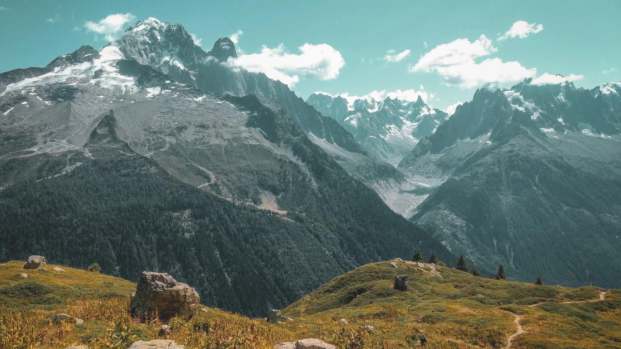 A majestic panorama of the Mont Blanc mountains, with wild landscapes and snow-capped peaks.