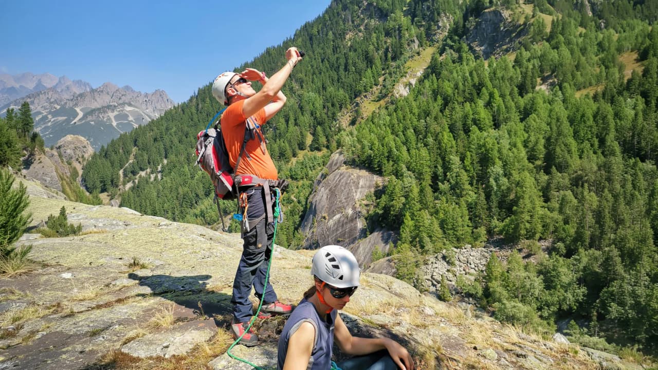 Two mountaineers on an expedition in Chamonix, with majestic green landscapes.