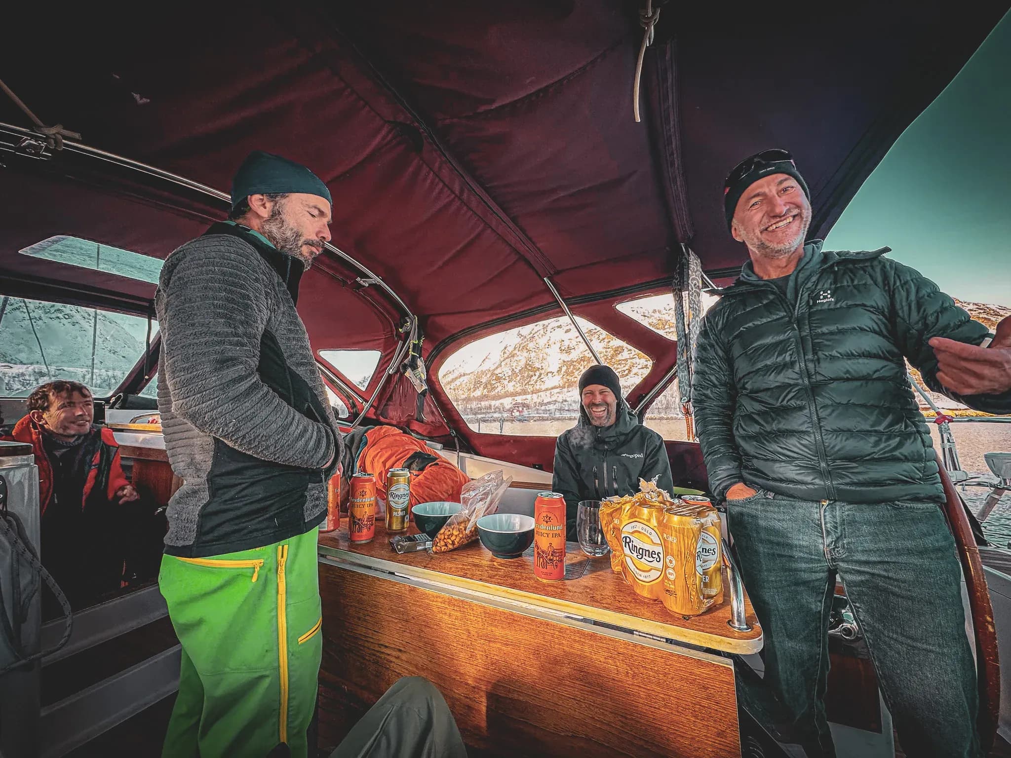 Sail through the Lyngen Alps, sharing laughs and drinks aboard a friendly sailing yacht.