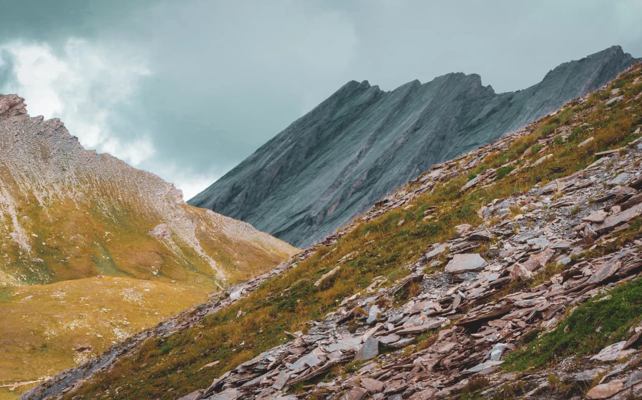 The mountainous landscape of the Vercors High Plateaux, majestic ridges and lush green slopes.
