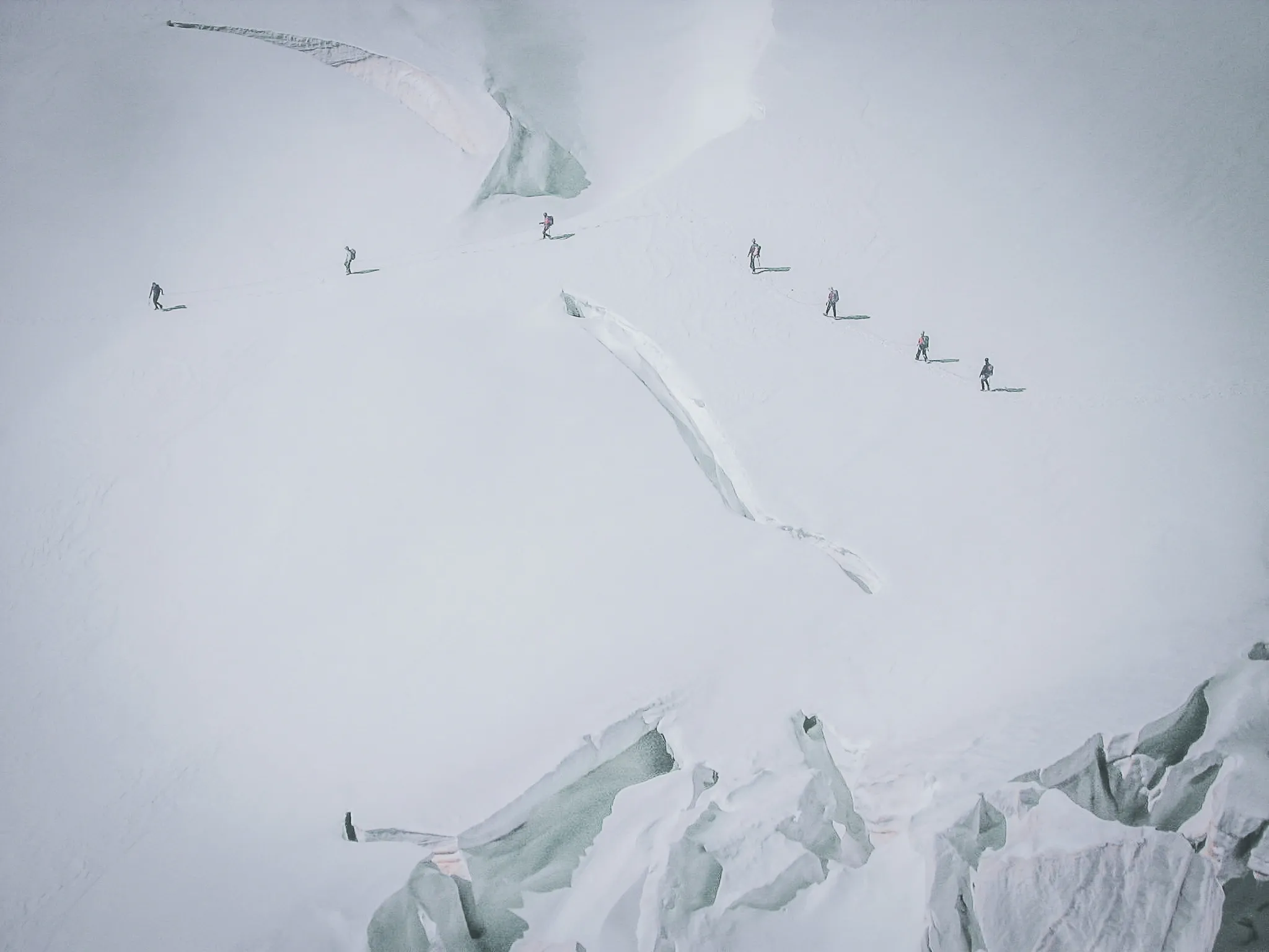 Hikers crossing the Aletsch glacier, surrounded by breathtaking icy landscapes.
