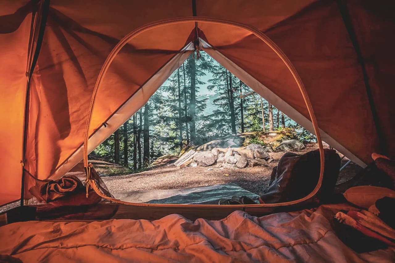 Magnificent views from an open tent, offering glimpses of the surrounding forest and rocks.