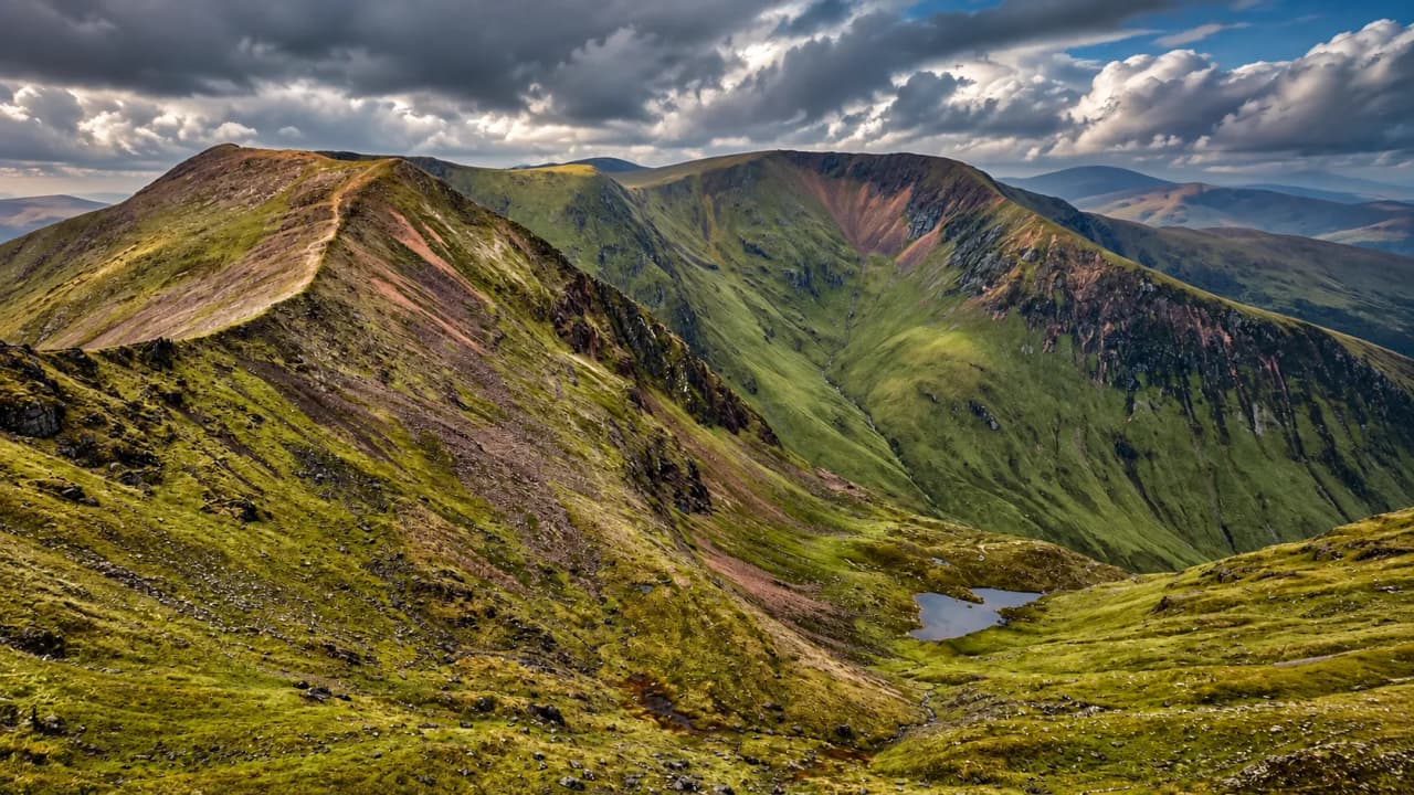 Landscapes of the Scottish Highlands: lush green valleys, majestic peaks and dramatic skies.