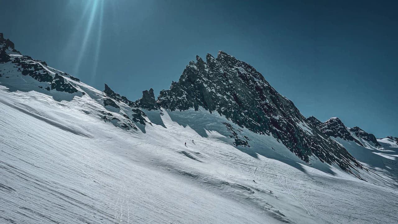 Sublime Alpine scenery, with glistening glaciers and majestic peaks under a blue sky.